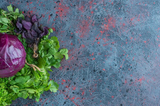 Free photo greens and purple cabbage, on the marble background.