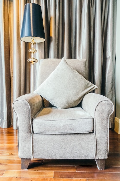 Free Photo grey armchair next to a lamp