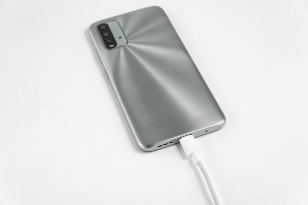 Grey cell phone connected to USB cable type C - Charging