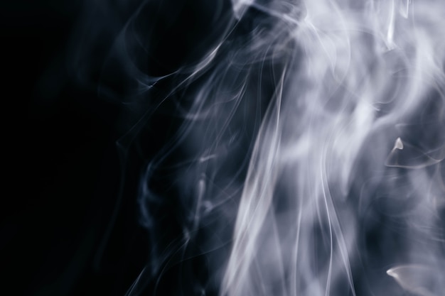 Free photo grey smoke waves on black background