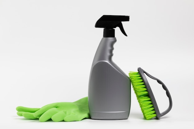 Free Photo grey spray bottle with green gloves and brush