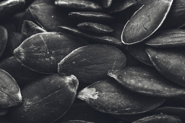 Free Photo greyscale closeup shot of a lot of pumpkin seeds - great for a black and white background