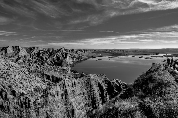 Free photo greyscale shot of the mountains near the lake in burujon, spain