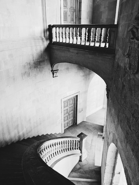 Greyscale shot of the stairs and halls of the Alhambra Palace in Granada, Spain