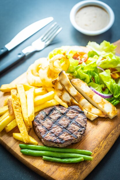 Grilled beef meat steak with french fries sauce 