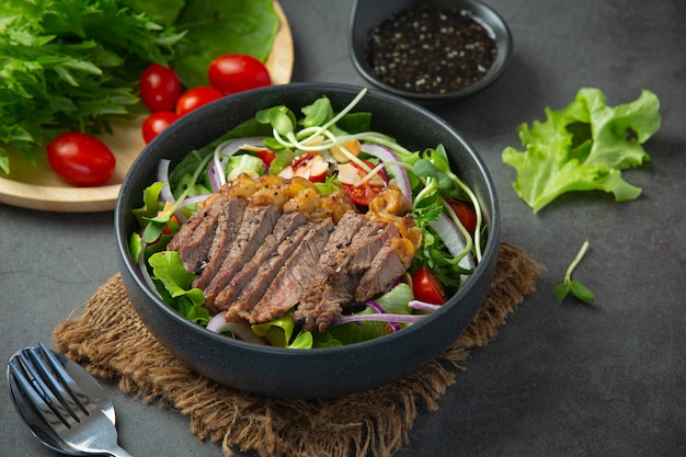 Grilled Beef Steak salad with vegetables and sauce. healthy food.