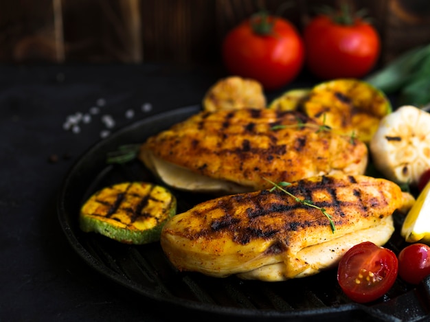 Grilled chicken breasts with vegetables