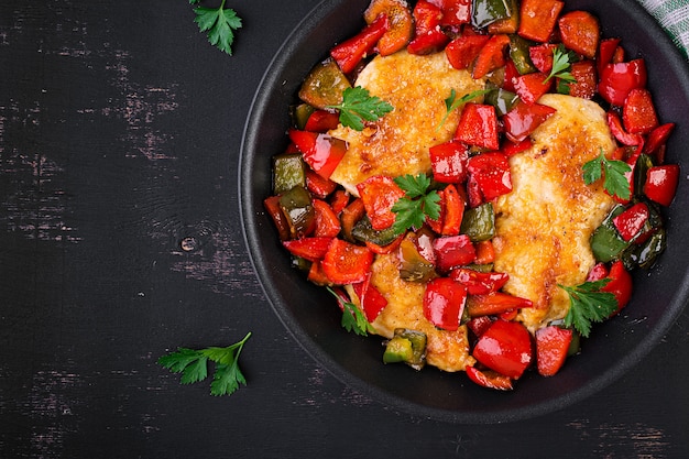 Grilled chicken fillets and sweet pepper on grill iron pan