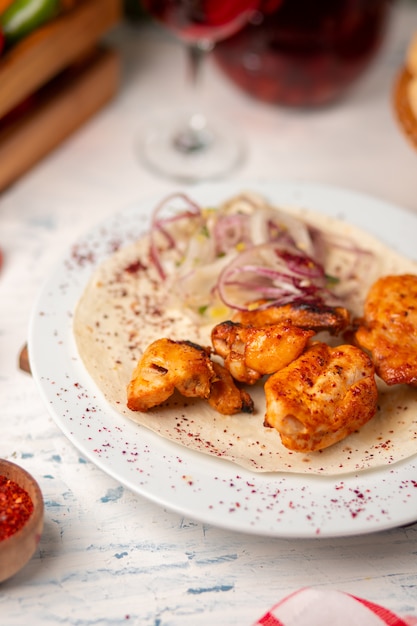 Free Photo grilled chicken nuggets, wings, breast with onion salad   