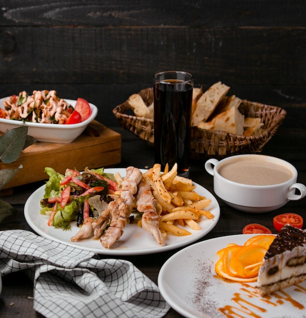 grilled chicken sticks with fries and salad