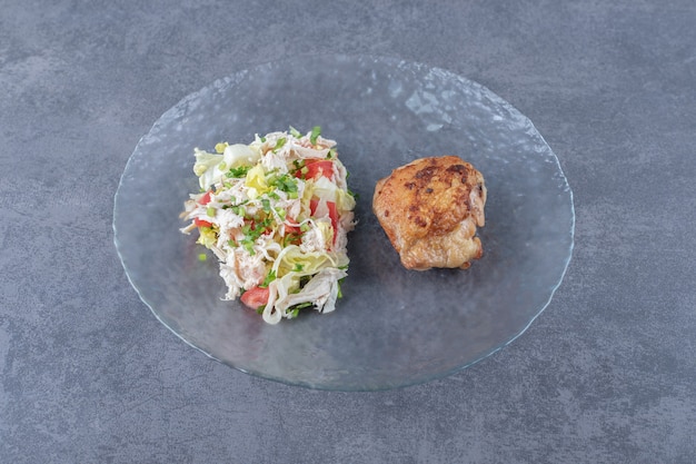 Free Photo grilled chicken and vegetable salad on glass plate.