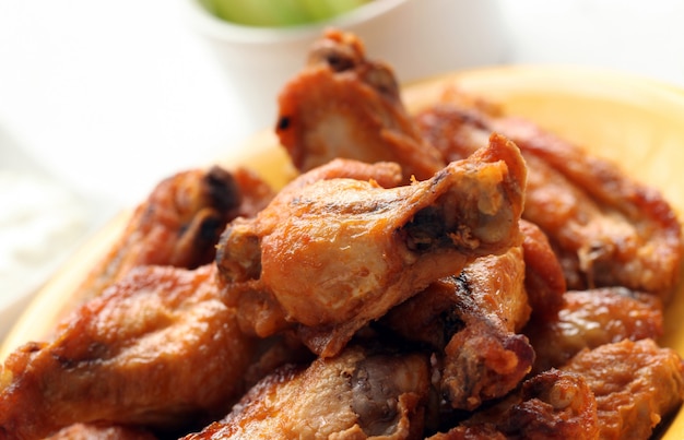 Free photo grilled chicken wings on a white table