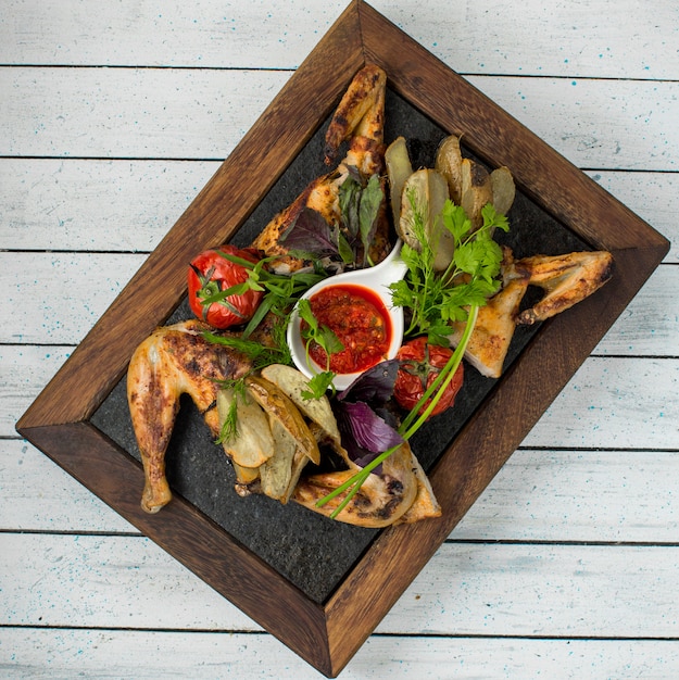 Grilled chicken with tomatoes, herbs and barbecue sauce.