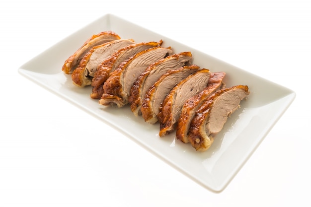 Grilled duck meat in white plate