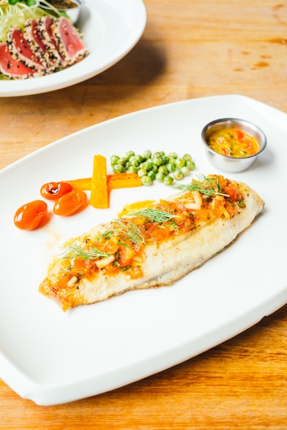 Free Photo grilled sea bass fish meat with sauce