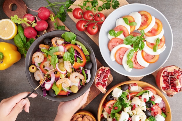 Free Photo grilled shrimps and fresh vegetable salad. healthy food. flat lay. italian caprese salad with tomatoes, basil, mozzarella, italian traditional caprese salad ingredients. mediterranean, greek salad.