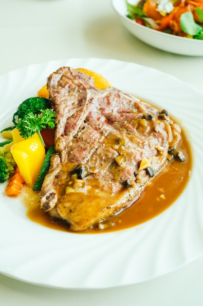 Grilled t-bone beef meat steak with vegetable