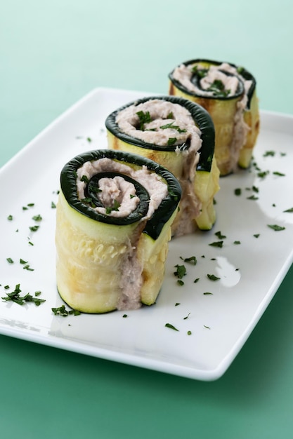 Grilled zucchini rolls stuffed with cream cheese and tuna