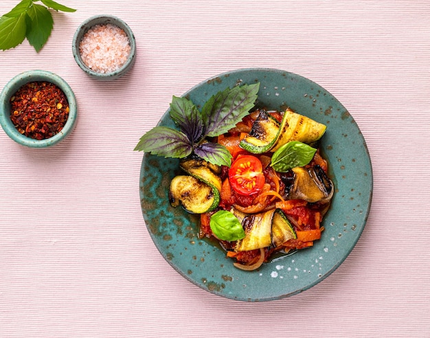 Grilled zucchini with vegetables in tomato sauce the concept of vegetarian food