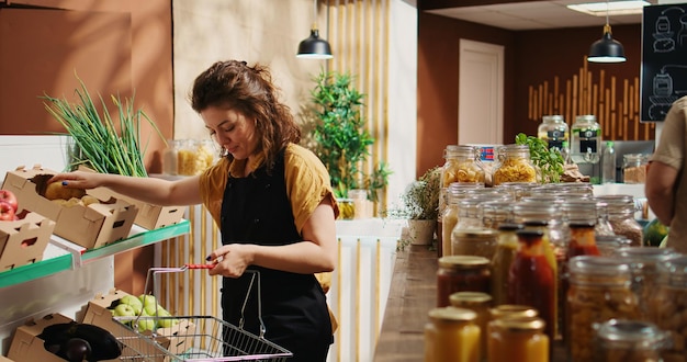 Grocery store employee restocks shelves