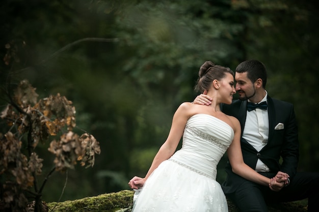 Groom and bride posing outdoors