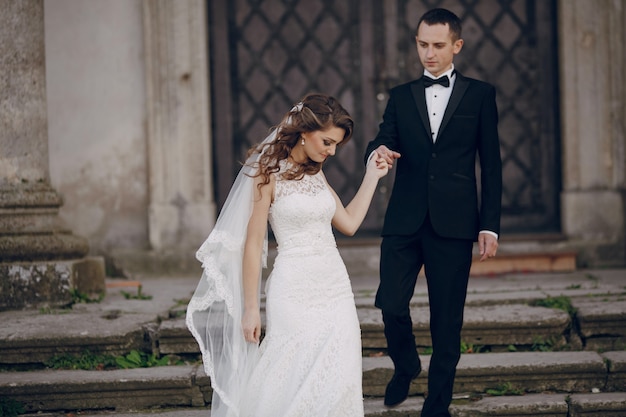 Groom and bride posing on the stairs