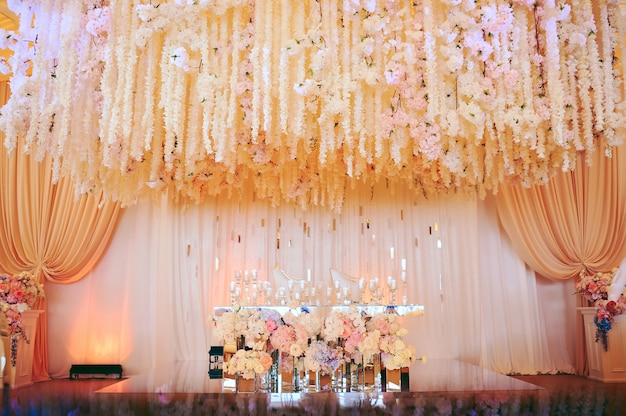 Groom and bride's wedding table decorated with flowers and candles