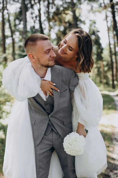 Groom and bride on their wedding day in forest