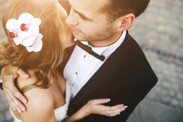 Free photo groom embracing his girlfriend