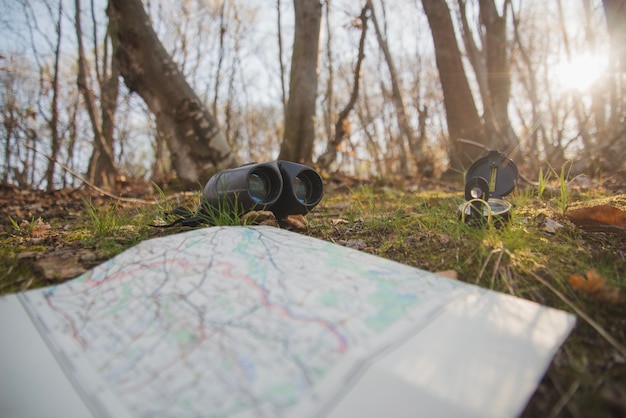 Free Photo ground with open map, compass and binoculars