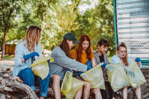 Free photo group of activists friends collecting plastic waste at the park