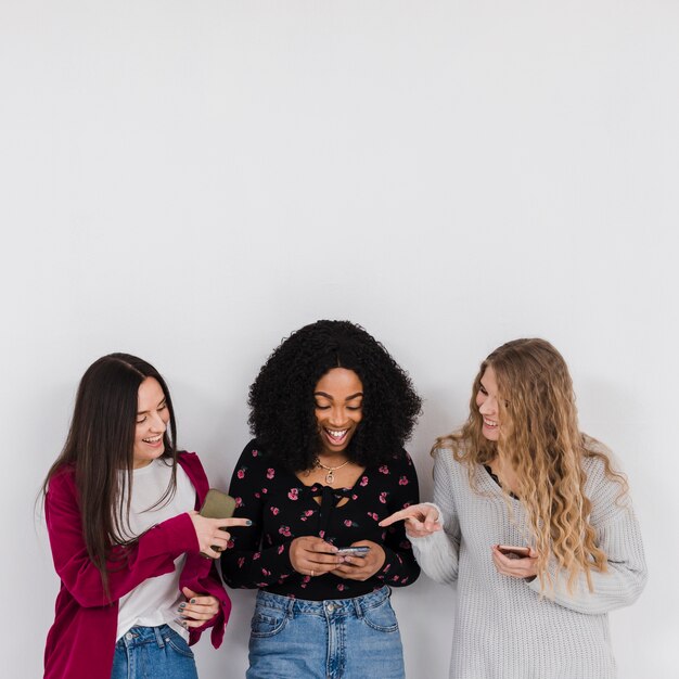 Group of best friends looking on a phone