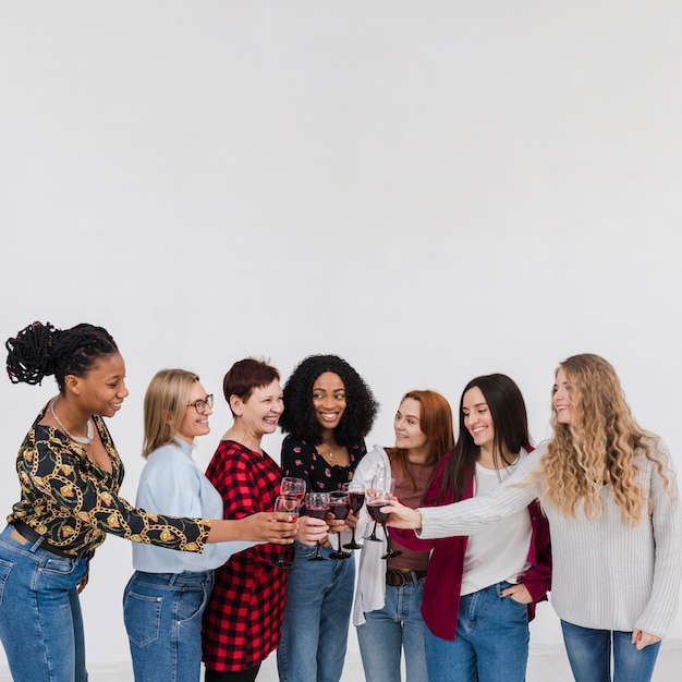 Free Photo group of best friends making a toast