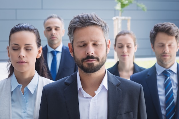 Free photo group of business people with eyes closed