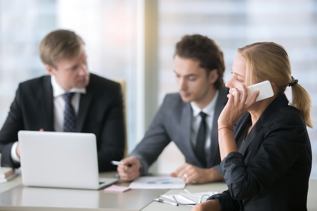 Group of businessmen at the office desk with laptop