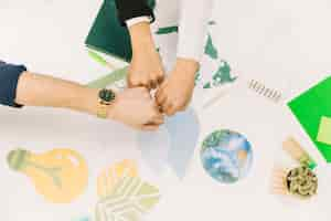 Free photo group of businesspeople fist bumping over desk