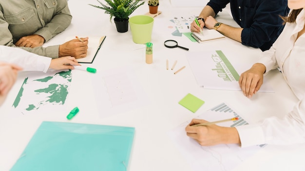 Group of businesspeople hand over white desk