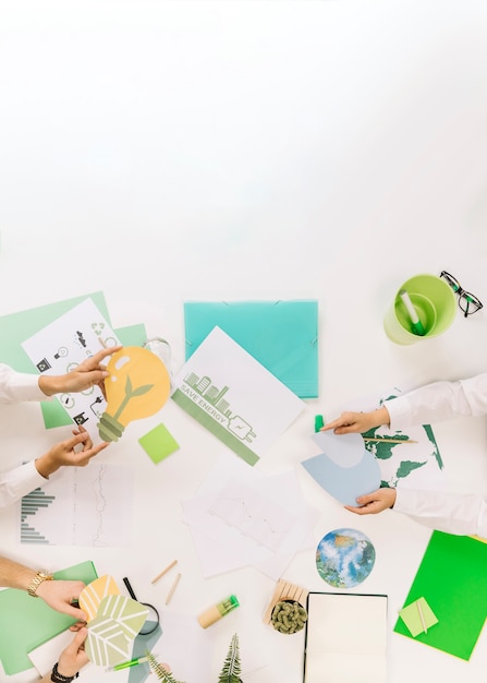 Free photo group of businesspeople holding energy saving icons over desk