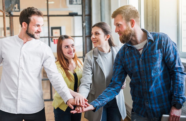 Free Photo group of businesspeople stacking their hand in office