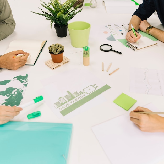 Group of businesspeople working on energy saving at workplace