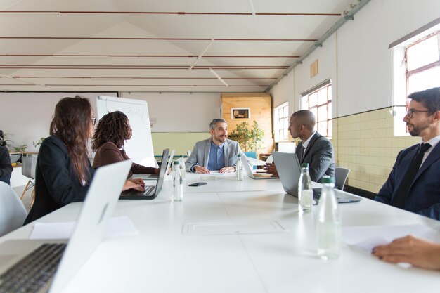 Group of busy managers during morning briefing