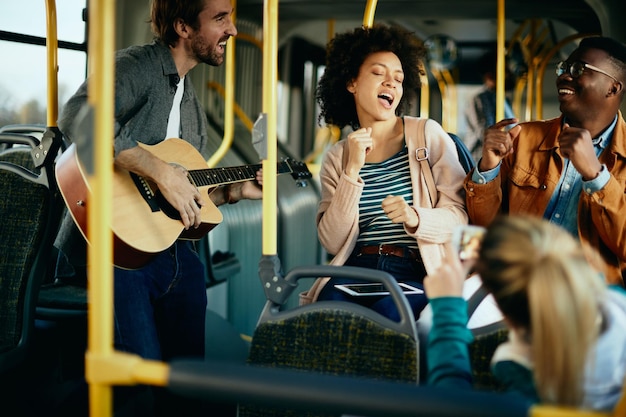 Group of carefree friends having fun while commuting by public transport