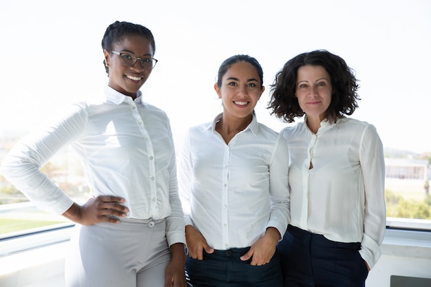 Free photo group of cheerful businesswomen smiling at camera