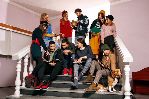 The group of cheerful happy students sitting in a lecture hall before lesson