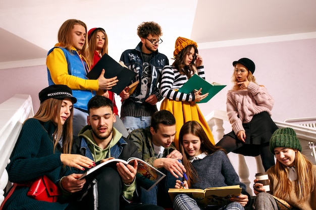 The group of cheerful happy students sitting in a lecture hall before lesson