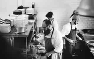 Free photo group of chefs working in the kitchen