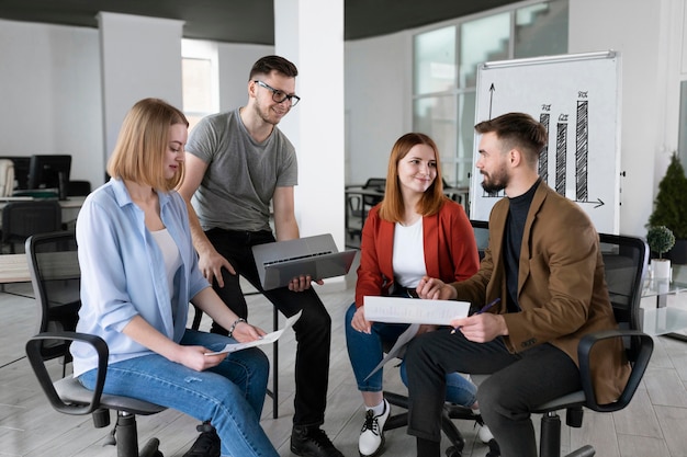 Free photo group of coworkers at the office talking