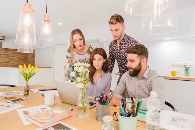 Group of coworkers watching laptop