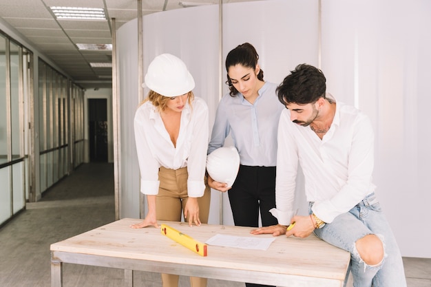 Group of engineers leaning over table