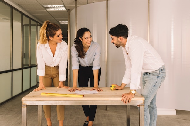 Group of engineers at wooden table